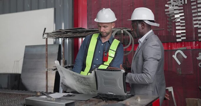 Sales Engineer Briefs Client in QC Workshop on Custom Fabrication Solutions