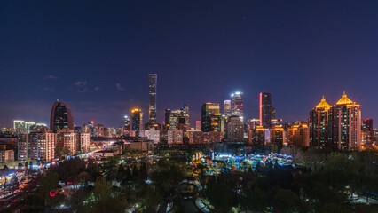 Obraz premium The dazzling night view of Beijing's CBD blends seamlessly with the green parks.