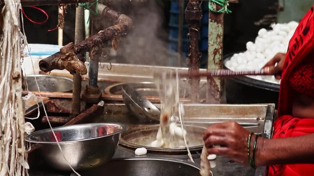 woman making silk thread. A traditional way of hand made silk production.