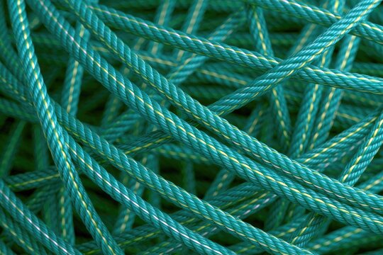 Abstract macro view of tangled teal and yellow braided synthetic rope