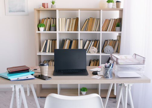 Business office. Productive workspace. Organized desk with laptop planning organizational notebook smartphone supporting task management.