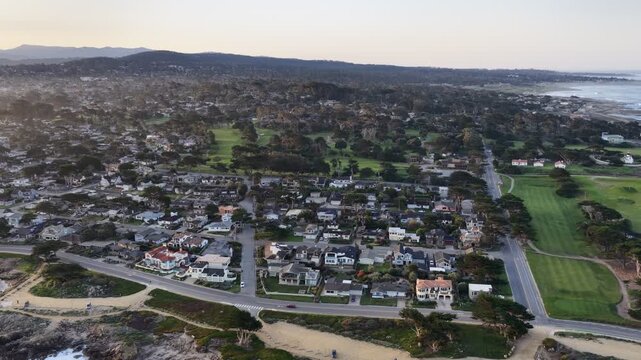 Monterey coastline aerial view with ocean waves, rocky shore, homes and golf course in California, USA. g.