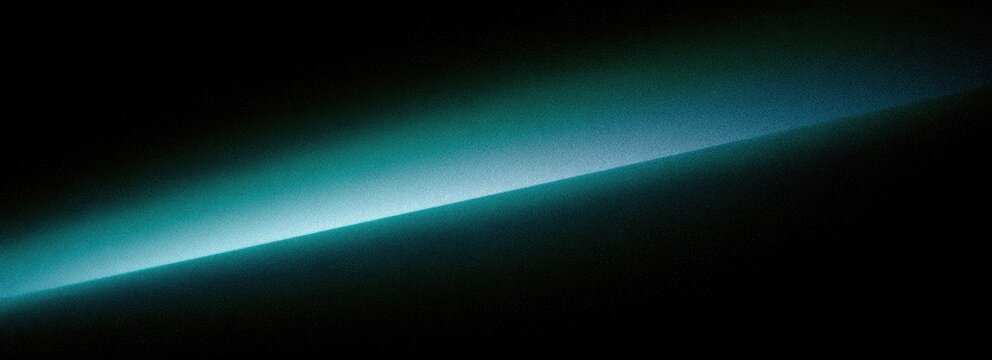 Abstract diagonal light streak in deep darkness