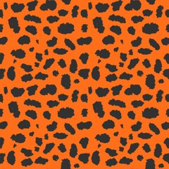 Seamless leopard print pattern with bold black organic spots on vibrant orange background. Stylish animal skin texture for textile, fashion, wallpaper, packaging, fabric, apparel, and surface design. © bixpicture