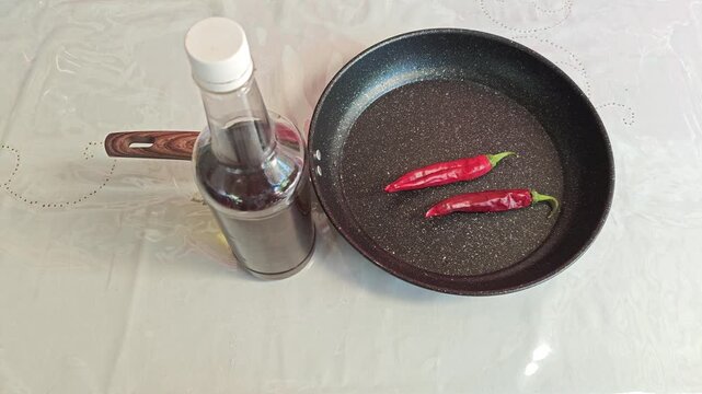 Placing Olive Oil Glass Bottle on Table with Brown Tablecloth