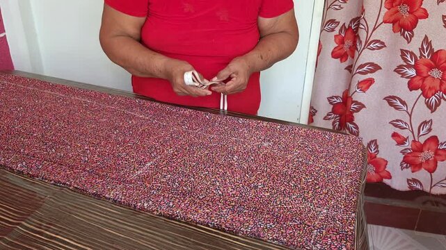 Seamstress Measuring Fabric with Tape Measure on Table