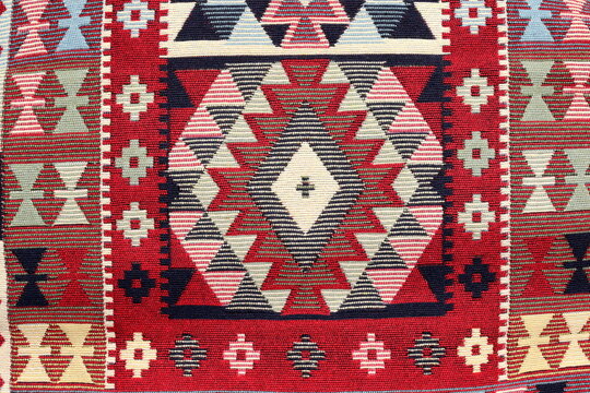 Traditional Balkan woven kilim rug texture with geometric geometric ethnic motifs and patterns