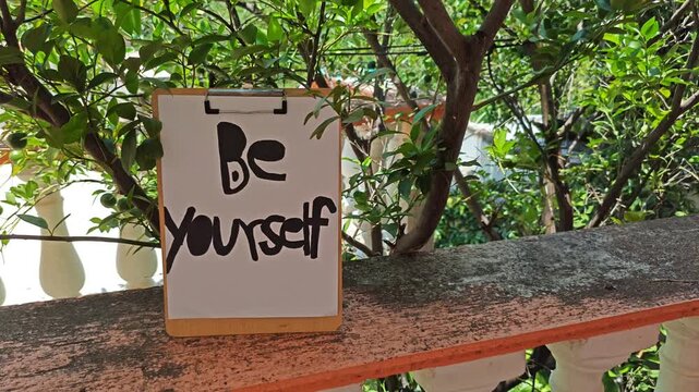 BE Yourself Motivational Sign on Outdoor Terrace near Mandarin Tree