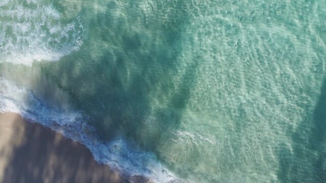 Aerial View of Gentle Waves on Sandy Beach
