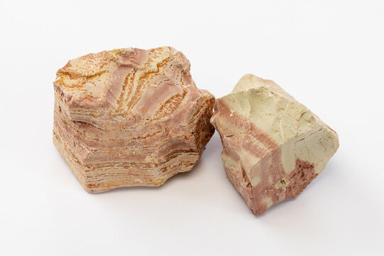 Close-up of Two Layered Sediment Soil Clods with Pink Beige Layers on White Background