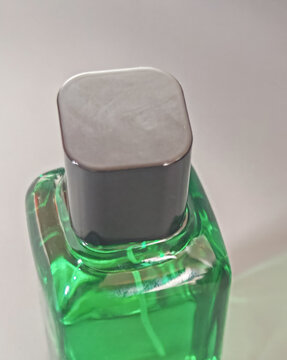 Minimal green glass cosmetic bottle with white cap on clean background, representing skincare packaging, beauty product design, freshness, purity, and modern personal care concept.