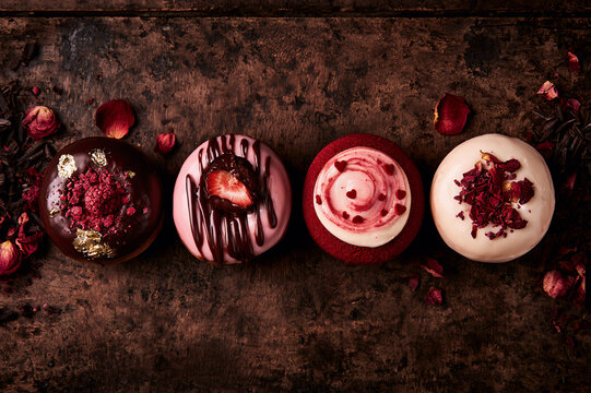 romantic gourmet chocolate and berry themed donuts on a dark table