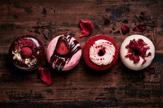 romantic gourmet chocolate and berry themed donuts on a dark table