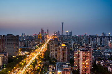 Obraz premium Night view of Beijing CBD, China: traffic trails and light trails, a bustling and panoramic urban landscape.