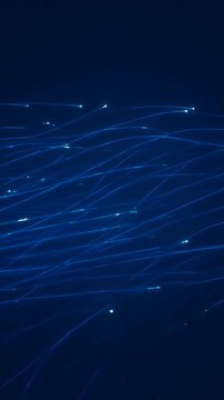 Abstract dark blue background with glowing light streaks, particle motion trails, flowing digital lines, technological connectivity and high speed data transfer flow