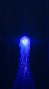 Abstract swirling blue light particles forming a glowing vortex, cosmic energy flow, motion graphics background for futuristic tech presentation