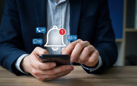 Businessman using smartphone with digital notification icons