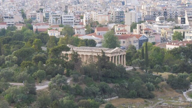 Panoramic view of the historical Ancient Agora in Athens, Greece, with its magnificent ancient ruins and urban backdrop.