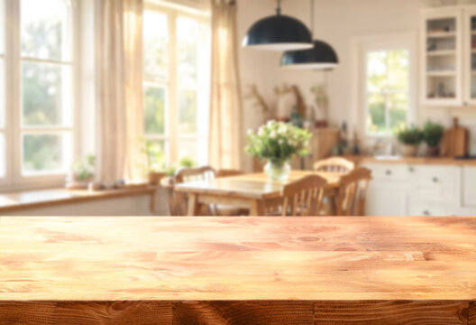 empty wooden table on foreground and bright cozy kitchen interior