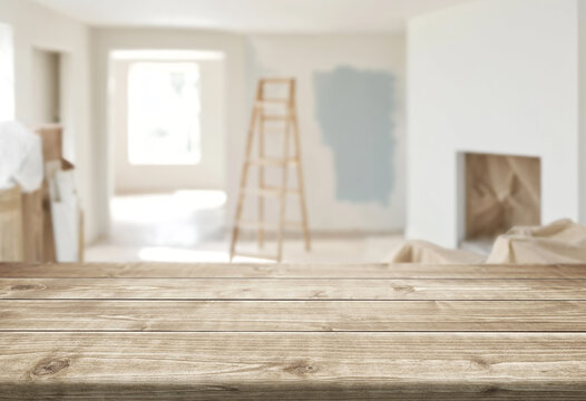 empty wooden table and blurred interior during renovation