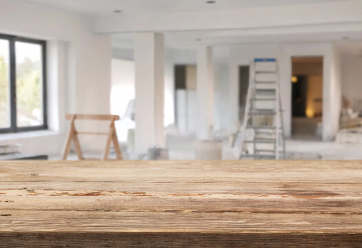 empty wooden table and blurred interior during renovation