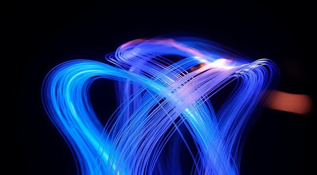 dynamic blue light trails forming abstract shapes on dark background, flowing energy ribbons, motion blur, fiber optics, tech stream overlay