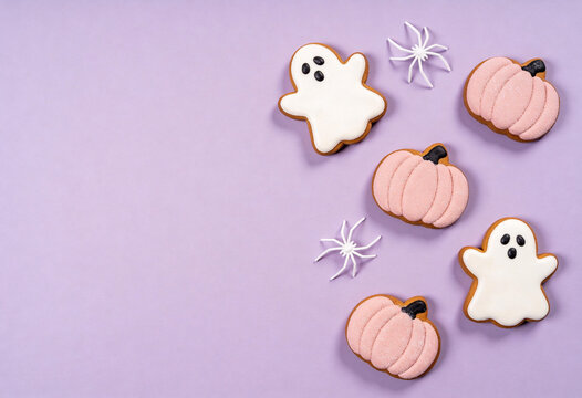 Halloween, ghost, pumpkin, spider, sweet, pastel, purple, autumn, halloween treats, ghost pumpkin spider top view layout, Halloween party sweets on purple surface with copy space for text.