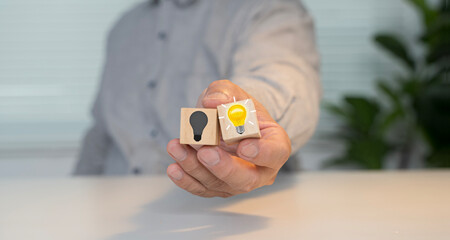 Hand Holding Lightbulb Blocks Showing Creative Idea and Innovation © jittawit21
