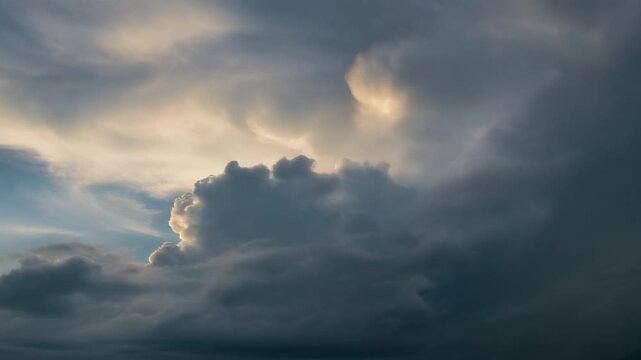 Dark storm clouds roll across dramatic sky as soft sunlight breaks through cloud edges, revealing layered atmospheric texture and cinematic natural lighting in slow motion.