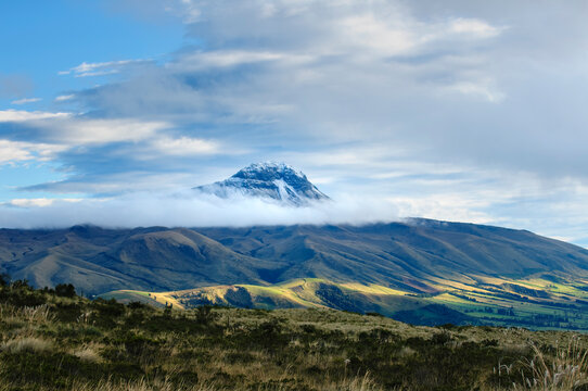 Majestic Snow-Capped El Corazon Volcano Amidst Clouds and Andean Valleys