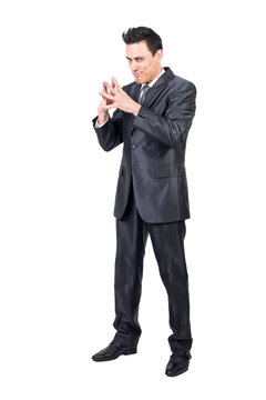 Scheming businessman looking at camera in studio