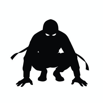 Silhouette of a crouching hooded figure with glowing eyes in the dark.