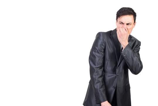 Man in elegant suit pinching nose in studio