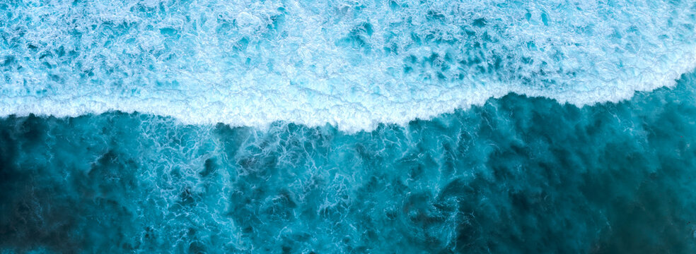 Banner Blue ocean Turquoise sea water white foam wave pattern splashing deep blue sea. Banner Tropical sea beach Seascape dark background splash on rock. Summer Ocean Surface wave with copy space