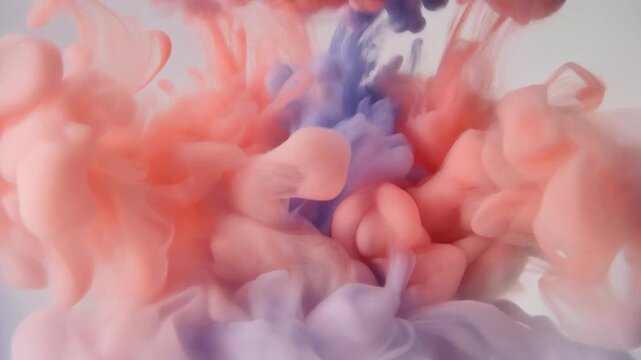 Watercolor pigment blooms through clear water as soft coral and lavender hues unfurl into organic cloudlike formations under gentle overhead lighting with elegant cinematic macro motion.