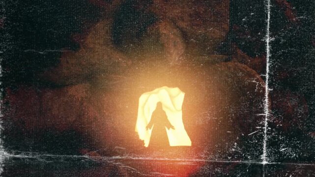 Glowing spiritual figure emerging with divine light from the darkness in a mysterious, ancient, religious themed motion footage.