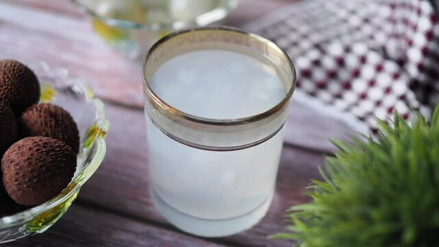 Making a simple drink with lychee fruit and water