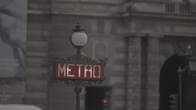 A close up of an ornate Art Nouveau Paris Metro entrance sign, its wrought iron lettering and lantern a classic symbol of the city.