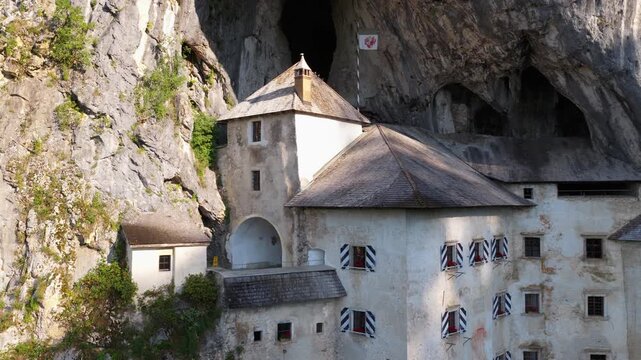 Predjama Castle built into a cliff in the Inner Carniola region of Slovenia - drone shot