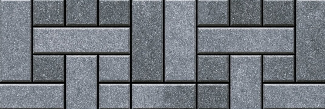Grey interlocking stone pavers forming a repeating geometric pattern