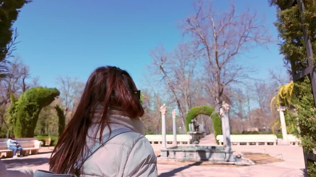 Aranjuez, Spain, March 2, 2026 Young woman walking through the gardens of the Royal Palace of Aranjuez