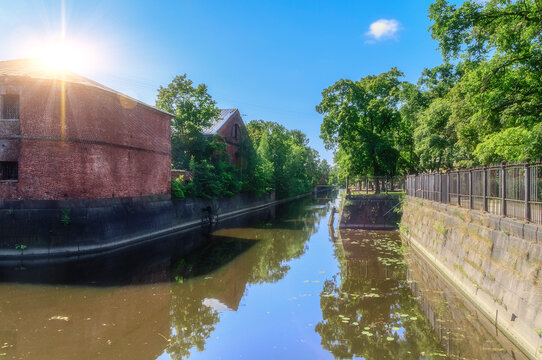 Kronstadt Russia. Historic Obvodny Canal also known as the Bypass Canal located in the fortress city of Kronstadt, on Kotlin Island near St Petersburg, Russia. Summer view, soft focus applied