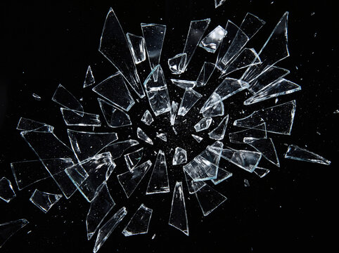 Sharp, clear glass shards on a dark background suitable for use in graphic design projects, web designs, and artistic compositions.