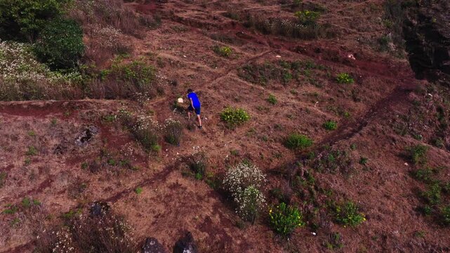 Person trekking on Mullayanagiri peak with surrounding trees and Mullayyana Giri Nandi Mantapa at Aralaguppe, Chikkamagaluru, Karnataka, india. day time, trucking shot, drone shot, 4k.