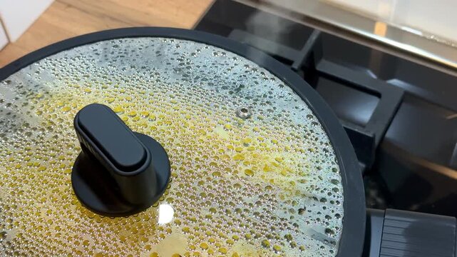 Boiling water in a pot, hot steam in the kitchen, cooking corn. Concept - burn from boiling water during cooking. High quality