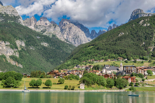lake of Molveno in Brenta Dolomites in Italy with village at the edge of water and peak mountain background