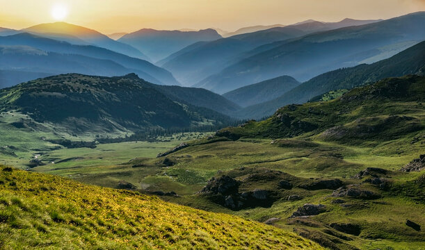 Carpathian mountains landscape. mMuntains  and hills at the sunset shiny  sky in Romania