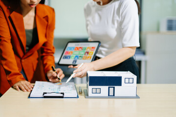 Fototapeta premium Real estate broker agent presenting and consult to customer to decision making sign insurance form agreement, home model, concerning mortgage loan offer in office