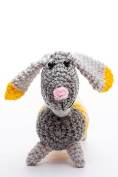 Knitted woolen dog on a white background