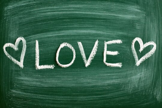 Chalkboard Love Message with Hearts Hand-Drawn with White Chalk on Green Board Surface